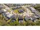 An aerial view shows the home nestled in a lush community near a lake at 4561 Cabello Loop, Kissimmee, FL 34746