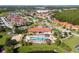 A captivating aerial view of the community showcasing the clubhouse, pool area, lush landscaping, and surrounding neighborhood at 4561 Cabello Loop, Kissimmee, FL 34746