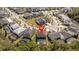 An aerial view shows the home nestled in a lush community near a lake at 4561 Cabello Loop, Kissimmee, FL 34746