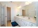 Bright bathroom featuring double sinks, a large vanity, and modern lighting fixtures at 4561 Cabello Loop, Kissimmee, FL 34746