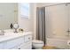 Well-lit bathroom featuring a white vanity, toilet, and a shower/tub combination with shower curtain at 4561 Cabello Loop, Kissimmee, FL 34746