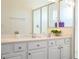Modern bathroom featuring double sinks with quartz counters and shower with glass door at 4561 Cabello Loop, Kissimmee, FL 34746