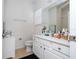 Bathroom featuring a white vanity and tile floors plus a large frameless mirror at 4561 Cabello Loop, Kissimmee, FL 34746