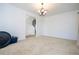 Carpeted bedroom featuring an open entry and a stylish chandelier at 4561 Cabello Loop, Kissimmee, FL 34746