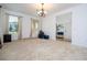 Large bedroom with carpet flooring, chandelier and open entrance to the foyer at 4561 Cabello Loop, Kissimmee, FL 34746