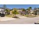 A cozy two-story home with a well-manicured lawn and driveway, surrounded by lush trees and a dark SUV parked nearby at 4561 Cabello Loop, Kissimmee, FL 34746