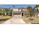 Charming two-story home boasts a neutral color palette, attached garage, and well-maintained front yard at 4561 Cabello Loop, Kissimmee, FL 34746