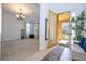 Bright foyer with tile flooring, a view into the living room, and a plant at 4561 Cabello Loop, Kissimmee, FL 34746