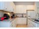 Bright kitchen featuring white cabinetry, modern appliances, and stone countertops at 4561 Cabello Loop, Kissimmee, FL 34746