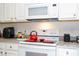 Bright kitchen featuring white cabinetry and modern appliances at 4561 Cabello Loop, Kissimmee, FL 34746