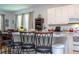 Bright kitchen featuring a center island with bar stool seating and white cabinets at 4561 Cabello Loop, Kissimmee, FL 34746