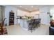 Well-lit kitchen with white cabinets, granite counters, a center island, and barstool seating at 4561 Cabello Loop, Kissimmee, FL 34746