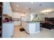 Bright kitchen featuring white cabinetry, granite countertops, and a functional center island at 4561 Cabello Loop, Kissimmee, FL 34746