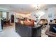 The living area features couches, tile flooring, and an open concept view of the dining room and kitchen at 4561 Cabello Loop, Kissimmee, FL 34746