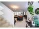 Open-concept living room and dining area with stairs on the left at 4561 Cabello Loop, Kissimmee, FL 34746