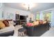 A stylish living room featuring a comfortable sofa, decorative pillows, and a modern entertainment center at 4561 Cabello Loop, Kissimmee, FL 34746