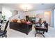 Spacious living room with a leather sofa, staircase and contemporary decor at 4561 Cabello Loop, Kissimmee, FL 34746