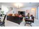Bright living room features a leather sofa, staircase, and modern decor, creating a cozy space at 4561 Cabello Loop, Kissimmee, FL 34746