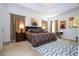 Spacious main bedroom with a tray ceiling, a king bed, matching lamps, and a decorative rug at 4561 Cabello Loop, Kissimmee, FL 34746