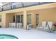 Outdoor patio with seating and barbeque area, view of backyard pool at 4561 Cabello Loop, Kissimmee, FL 34746