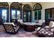 Outdoor patio with a fire pit surrounded by comfortable seating and an arched design at 4561 Cabello Loop, Kissimmee, FL 34746