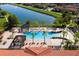 Enjoy this beautiful community pool with lounge chairs and palm trees with gorgeous views of the lake at 4561 Cabello Loop, Kissimmee, FL 34746