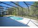 Backyard pool with screened enclosure, scenic trees behind at 4561 Cabello Loop, Kissimmee, FL 34746