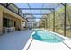 Backyard pool with screened enclosure, featuring outdoor seating area and view of the home at 4561 Cabello Loop, Kissimmee, FL 34746