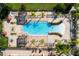 Aerial view of a stunning community pool featuring shaded lounge areas and ample space for residents to relax and enjoy the sun at 4561 Cabello Loop, Kissimmee, FL 34746