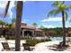 Community pool with ample lounge seating, shaded pergola, and lush landscaping at 4561 Cabello Loop, Kissimmee, FL 34746