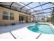 Backyard pool with screened enclosure, featuring outdoor seating area and view of the home at 4561 Cabello Loop, Kissimmee, FL 34746
