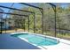 Backyard pool with screened enclosure, featuring view of adjacent yard at 4561 Cabello Loop, Kissimmee, FL 34746
