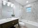 Charming bathroom features a bathtub, shower, and elegant vanity with stylish mirror and lighting at 4905 Tam Dr, Orlando, FL 32808