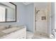 Updated bathroom featuring marble walk-in shower, modern vanity and sink at 4907 Silver Oaks Vlg # D, Orlando, FL 32808