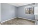 Empty bedroom with vinyl floors and one window at 4907 Silver Oaks Vlg # D, Orlando, FL 32808