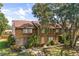 Townhouse exterior with brick accents, mature trees, and well-maintained landscaping at 4907 Silver Oaks Vlg # D, Orlando, FL 32808