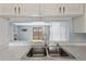 Bright kitchen sink with view of the living room and sliding glass doors at 4907 Silver Oaks Vlg # D, Orlando, FL 32808