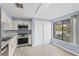 Kitchen with stainless steel appliances, white cabinetry, and natural light at 4907 Silver Oaks Vlg # D, Orlando, FL 32808