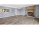 Open-concept living space featuring a brick fireplace and modern flooring at 4907 Silver Oaks Vlg # D, Orlando, FL 32808