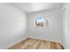 Small simple bedroom with wood floors, window, and white trim at 5603 Marie Ct, Orlando, FL 32818