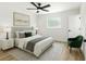 Comfortable main bedroom featuring neutral decor, a ceiling fan, and ample natural light at 5603 Marie Ct, Orlando, FL 32818