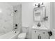 Modern bathroom with a marble tiled shower, white vanity, black fixtures and a clean, bright space at 5603 Marie Ct, Orlando, FL 32818