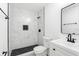 Modern bathroom featuring black fixtures, a glass walk-in shower, and a marble tile surround at 5603 Marie Ct, Orlando, FL 32818