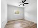 Clean bedroom with wood floors, a ceiling fan, natural light, and a minimalist design at 5603 Marie Ct, Orlando, FL 32818