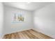 Bright bedroom with natural light, light wood floors, and crisp white walls at 5603 Marie Ct, Orlando, FL 32818