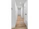 Well-lit hallway featuring light wood floors, white walls, and simple, modern design at 5603 Marie, Orlando, FL 32818