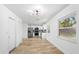 Open-concept layout showing the kitchen with stainless steel appliances and wood flooring at 5603 Marie Ct, Orlando, FL 32818