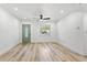 Bright living room with new floors, fresh paint and contemporary ceiling fan at 5603 Marie Ct, Orlando, FL 32818