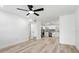 Bright living room with new floors that flows into a modern kitchen with stainless steel appliances at 5603 Marie Ct, Orlando, FL 32818