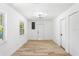 Bright living room with white walls, wood floors, natural light and modern light fixture at 5603 Marie Ct, Orlando, FL 32818